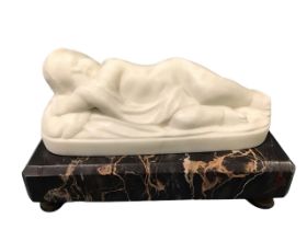 A Victorian carved marble figure of a sleeping infant, mounted on a chamfered rectangular Portoro