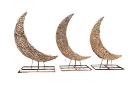 Three woven willow crescent moon sculptures, supported on rectangular metal stands. (84in) (3)