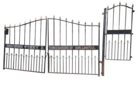 A set of large entranceway gates, the main arched opening with spear finials having mid-rail