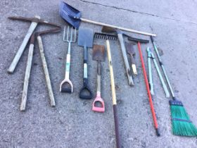 Miscellaneous garden tools - two spades, a rake, a garden fork, a pickaxe, a mattock, a billhook,