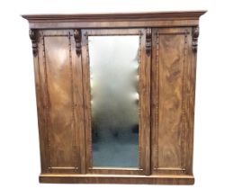 A Victorian mahogany wardrobe, the moulded cornice and plain frieze above a central mirrored door