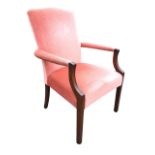 A Georgian style mahogany Gainsborough armchair the arched rectangular upholstered back and seat