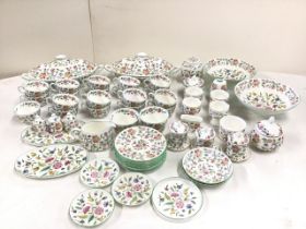 An extensive collection of Minton Haddon Hall pattern ceramics - cups, saucers, plates, jug, sugar