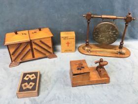 An Edwardian oak and brass dinner gong on stand, a marquetry card box inlaid with suits, dated 28; a