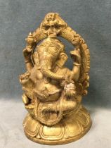 An Indian brass figure of Ganesh, the elephant headed god seated with a rat & snakes on a lotus