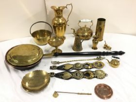 A collection of brass - a Victorian bedwarmer, a ewer, a bowl, a WWI shell case, a pair of leather