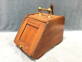 A Victorian oak coal scuttle, the rectangular top with brass dumbbell handle, above a panelled slant