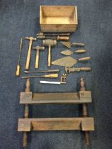 A box of miscellaneous tools - a mallet, trowels, hammers, a wrench, rulers, etc.; together with a