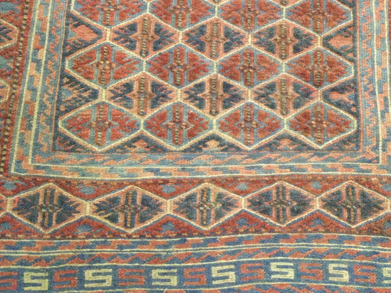 A Kurdish wool rug, the polychrome lozenge lattice field within geometric and conforming borders. ( - Image 3 of 3