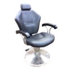 A Foxhunter upholstered barbers chair, the hexagonal reclining back with adjustable headrest above a