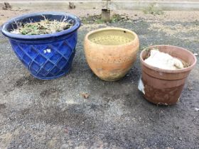 A blue glazed ceramic garden pot with moulded lattice decoration; a hand-thrown terracotta planter