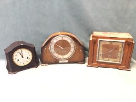 A deco mahogany mantel clock, the stepped case with ebonised stringing above a square glazed dial,