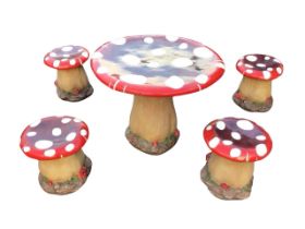 A painted toadstool shaped childrens garden table and stool set, the pieces with brightly coloured