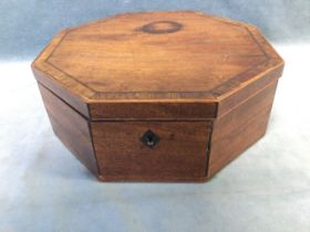 A Victorian octagonal mahogany workbox with crossbanded and chequer inlaid top, the interior with