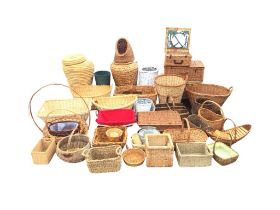 A collection of miscellaneous cane baskets - shopping, laundry, picnic hampers, wast paper, a cat
