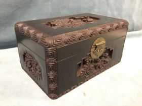 A Chinese carved hardwood box, the rectangular top and sides carved in high relief with figures in