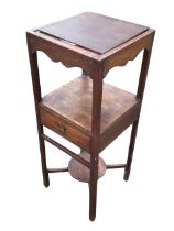 A Georgian oak washstand, the later square top revealing circular apertures for basin and beakers