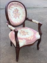 A Louis XV style hardwood armchair, the oval medallion back above a serpentine fronted seat, flanked