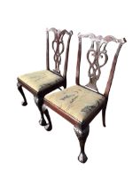 A pair of Irish Chippendale style mahogany chairs, the wavy backs carved with shells and foliage