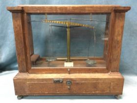 A mahogany cased set of laboratory scales by Becker Fils & Co, the instrument in glazed case with