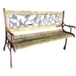 A 4ft garden bench, the pierced rose cast back panel above teak slats, raised on cast iron