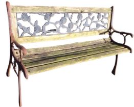 A 4ft garden bench, the pierced rose cast back panel above teak slats, raised on cast iron