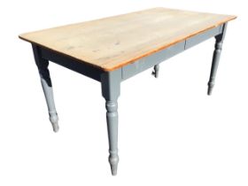 A Victorian pine kitchen table, the rectangular scrubbed top above a painted base, raised on