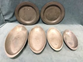 A set of four American mid-century pewter elliptical graduated stacking serving dishes by Wilton -