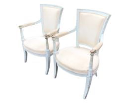 A pair of painted French Directoire style upholstered open armchairs, the flared rectangular backs