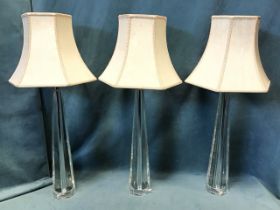 A set of three contemporary chamfered glass tablelamps with tapering columns, made for Laura Ashley,
