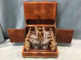 A C19th French Empire kingwood and marquetry coffret-á-liqueurs, the serpentine cabinet with