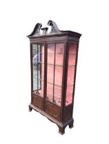 An Edwardian mahogany Chippendale style display cabinet, the pierced swan-neck pediment with
