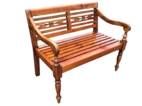A regency style two-seater hardwood conservatory bench, the rectangular back with grooved and