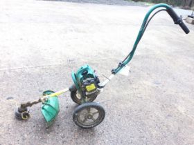 A Coopers petrol strimmer on trolley type stand.