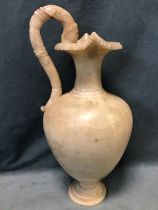 A Roman style Italian Grand Tour carved alabaster ewer, the egg and dart rim above a narrow neck and