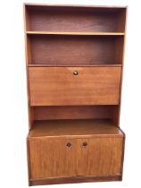 A 1970s teak bureau bookcase, the rectangular top with two open shelves above a fall-front desk with