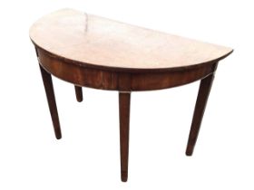 A Georgian demi-lune side table, the semicircular top above a cockbeaded apron, raised on tapering