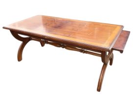 A regency style mahogany & yew extending coffee table, the moulded crossbanded top with pull-out