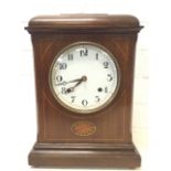 A late Victorian mahogany mantle clock with caddy-top case inlaid with boxwood stringing and oval