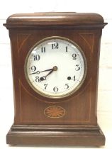 A late Victorian mahogany mantle clock with caddy-top case inlaid with boxwood stringing and oval