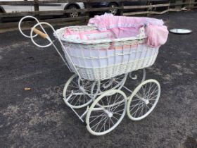 A Victorian style wicker perambulator, the oval basket body with fabric lining and frilled hood on a