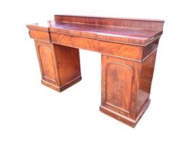 A Victorian mahogany twin pedestal sideboard, the raised back on an inverted breakfront top above