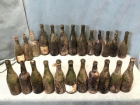 Twenty-five old wine & champagne bottles brought up from a farmhouse cellar, all coloured glass. (