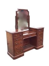 A Victorian mahogany breakfront dressing table, the shaped mirror tilting on later square supports