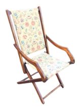 An Edwardian mahogany childs folding armchair, the rectangular fabric back and seat flanked by