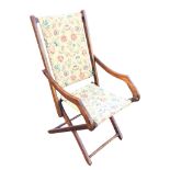 An Edwardian mahogany childs folding armchair, the rectangular fabric back and seat flanked by