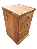 An Edwardian style oak two-drawer filing cabinet, the moulded top above raised panelled drawers with