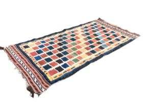 A Turkish kilim rug, the cream field woven with allover toothed square motifs, within geometric