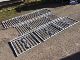 A set of galvanised railings and gates with square spindle bars to frames with scrolled