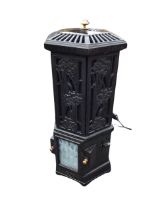 A cast iron Esse stove style electric heater, the pierced hexagonal top with copper mushroom